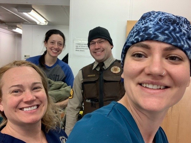 Dr. Laurie Meythaler-Mullins, Abby Klager, tribal police officer James Kvamme, and veterinary student Keira Sztukowski visit Emmonak, Alaska, January 2020. (UAF/CSU photo)