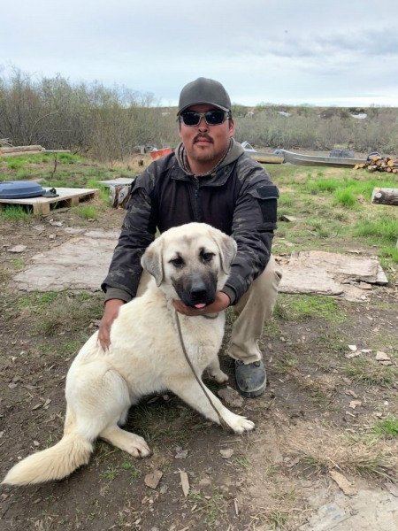Steven, a police officer in Napakiak, Alaska, with his dog. (UAF/CSU photo)
